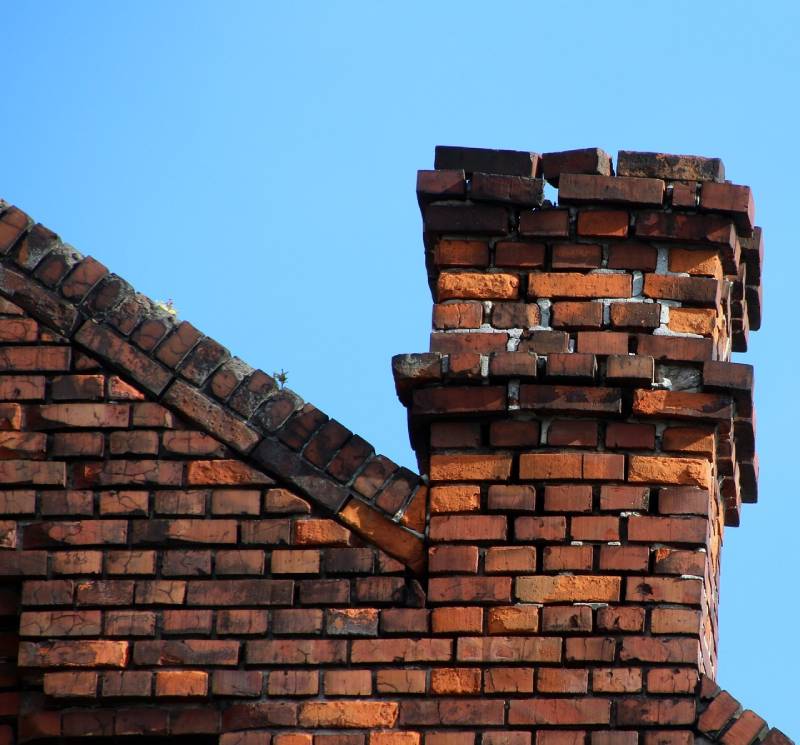 Signs Your Lake Angelus Home Needs a Chimney Inspection Damaged chimney on an Lake Angelus home showing cracks and missing mortar